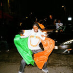 Ivorian football fans joyfully celebrate their AFCON 2024 victory in the streets of Paris, showcasing vibrant team colors and national pride