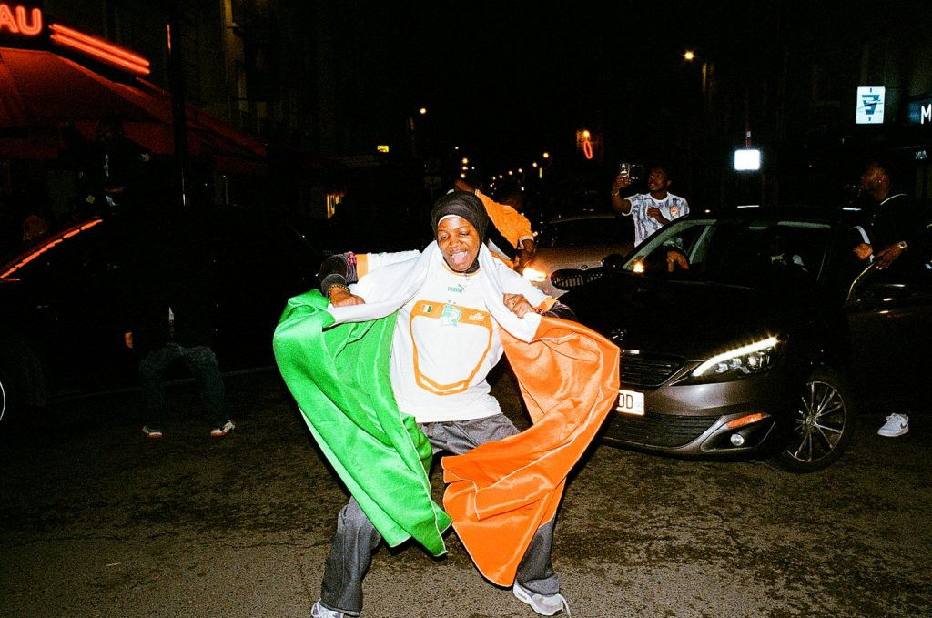 Ivorian football fans joyfully celebrate their AFCON 2024 victory in the streets of Paris, showcasing vibrant team colors and national pride