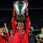 Manchester United player David Beckham May 1999 with the Champions League Cup trophy after his team beat Bayern Munich 2-1 to win the UEFA Champions Cup final at the Nou Camp Stadium in Barcelona. Pic via Mirrorpix.