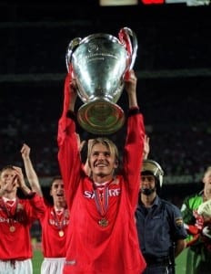 Manchester United player David Beckham May 1999 with the Champions League Cup trophy after his team beat Bayern Munich 2-1 to win the UEFA Champions Cup final at the Nou Camp Stadium in Barcelona. Pic via Mirrorpix.