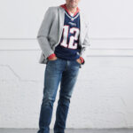 Man wearing a New England Patriots jersey with jeans and an unstructured blazer