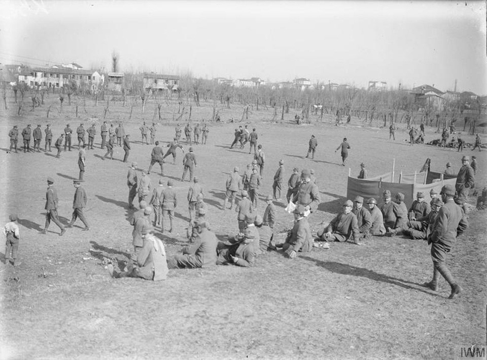 An impromptu game of football kicks off between British and Italian troops, as others take some time out to rest on the hills and watch on in 1917. Photo courtesy of Imperial War Museum