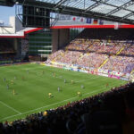 Soccer players celebrating a goal during a friendly match