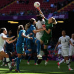 Jenny Bindon of New Zealand punches the ball clear during a Group E match against Brazil at the 2012 Olympic Games, highlighting the team's competitive spirit