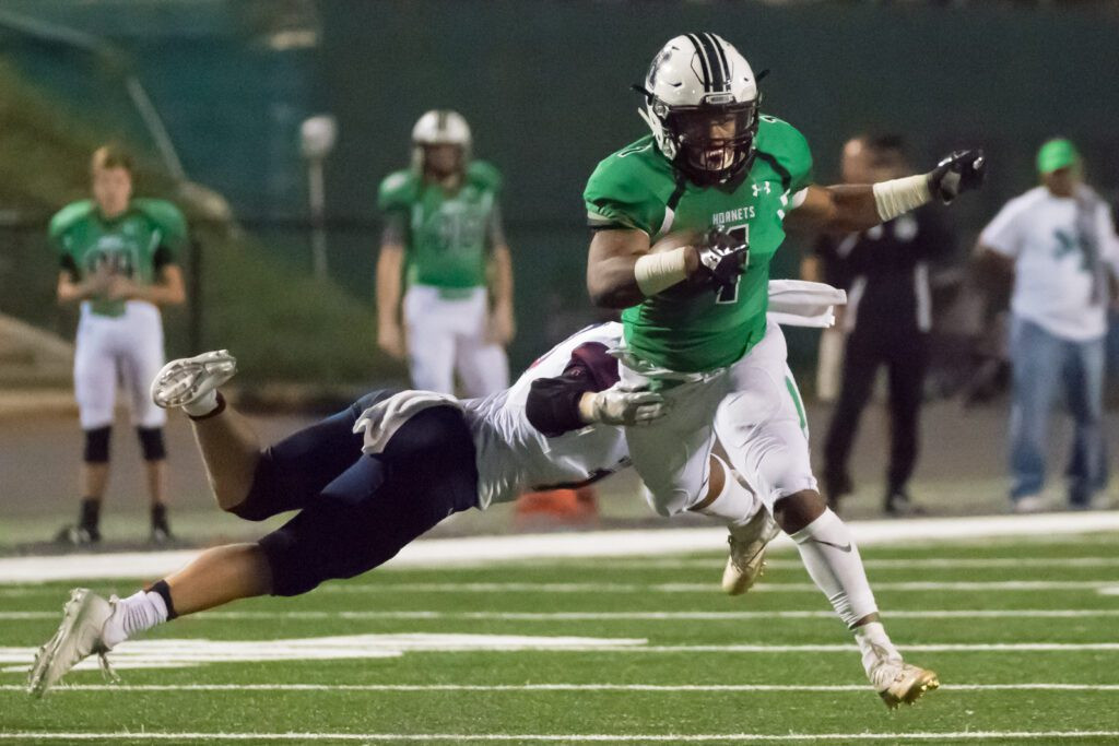 Roswell's Sheldon Evans avoids tackle in high school football game.