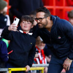 Ryan Reynolds poses for a selfie with a young Wrexham fan