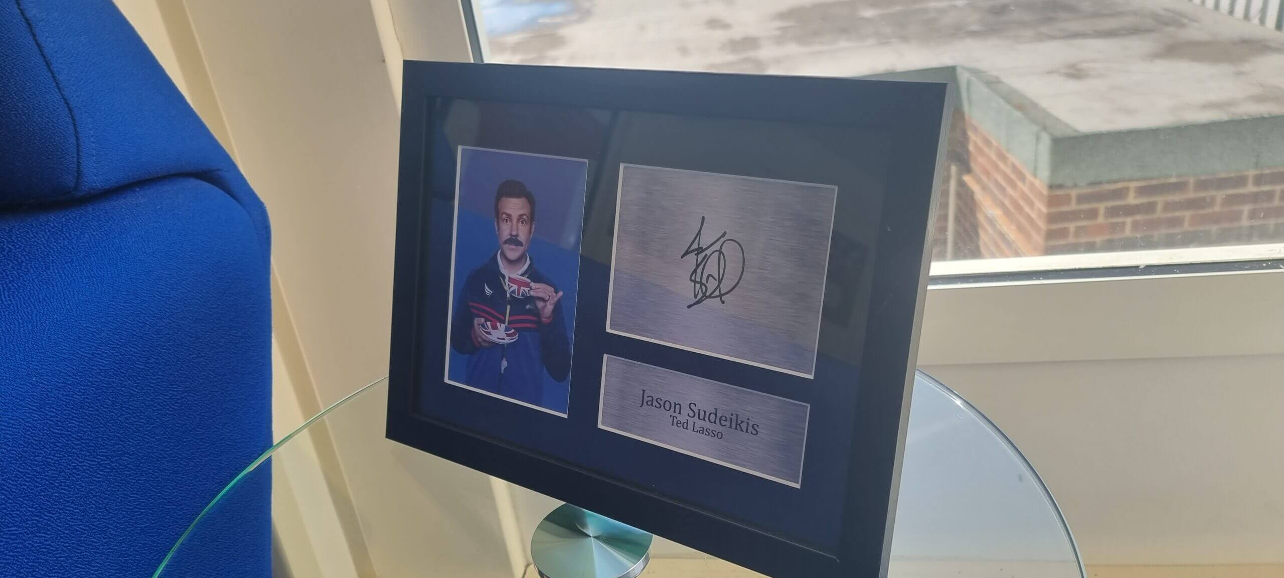 A framed copy of the show’s ‘BELIEVE’ motto and a signed photo of star Jason Sudeikis