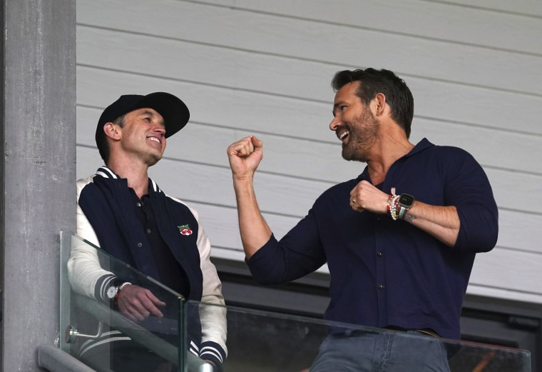 Ryan Reynolds and Rob McElhenney celebrate Wrexham AFC's promotion
