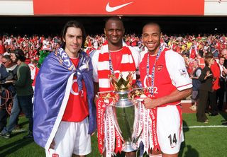 Arsenal trio celebrates with the Premier League trophy