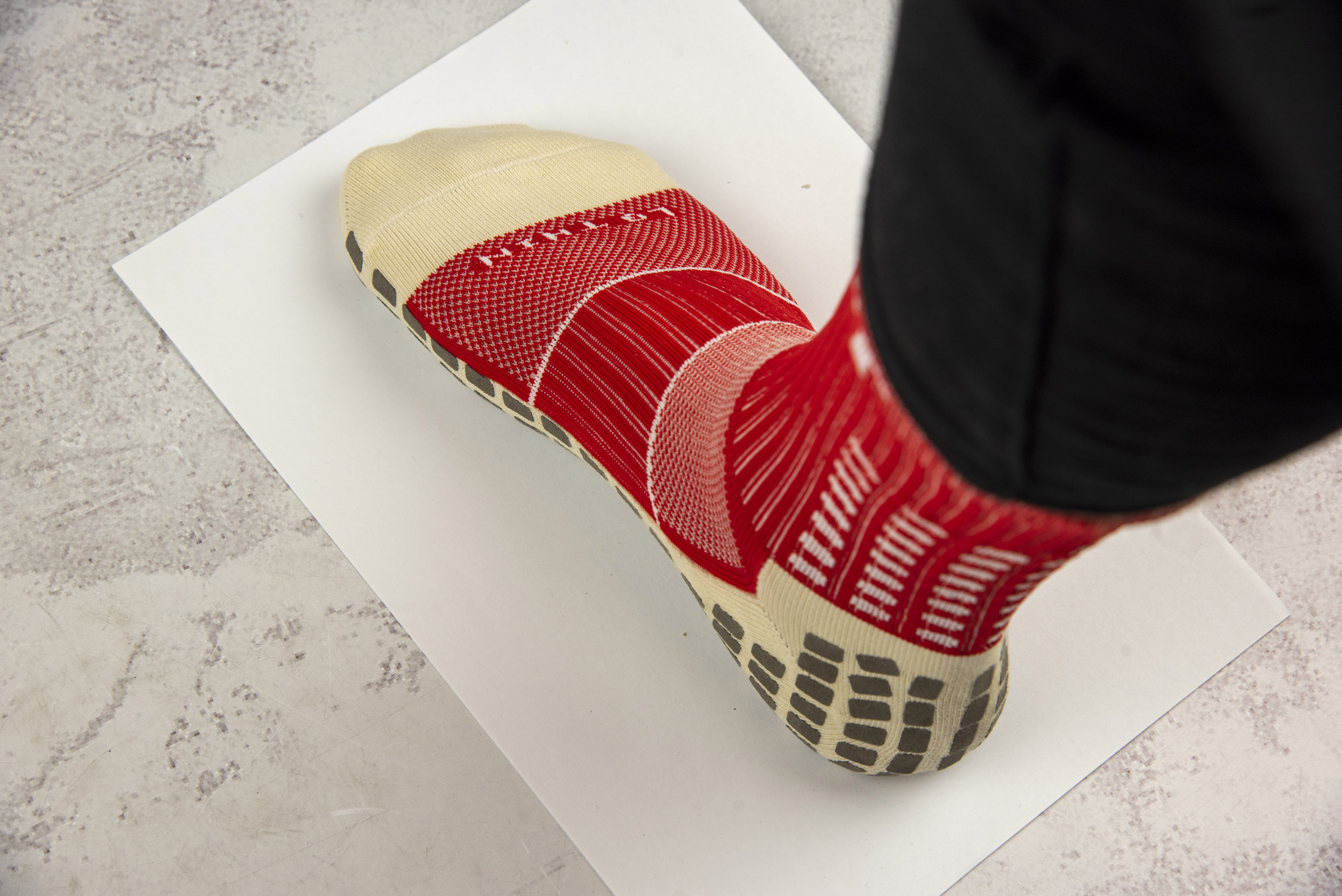 Foot in sock on clean paper