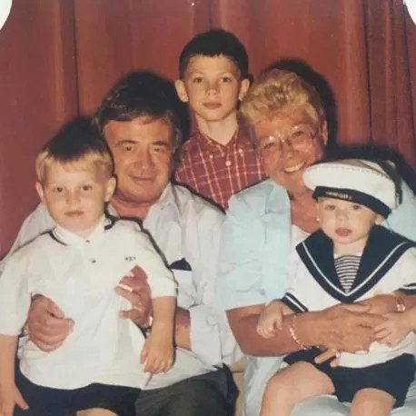 Allan with wife Beryl and his three grandchildren Joshua, Phil and Alex, capturing a cherished family moment filled with love and connection.