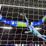 Thibaut Courtois stretches for the ball against Manhcester City