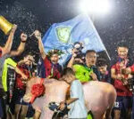 Fans in traditional dress celebrating during the China Football League's Guizhou Village Super League