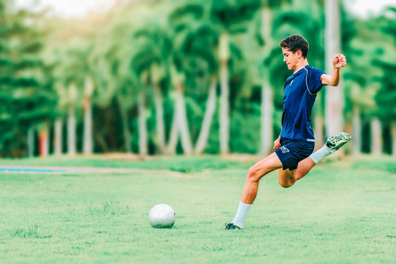 Young soccer player training with focus