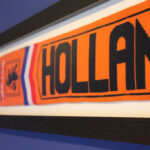 Football scarf draped across wall with team logo