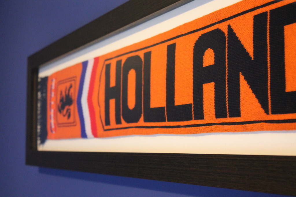 Football scarf draped across wall with team logo