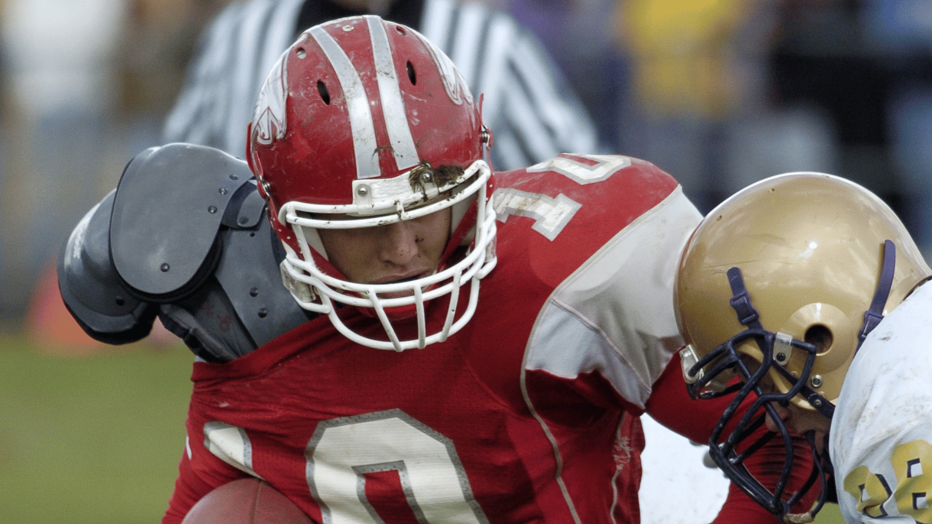 RB in a red uniform shedding a tackler