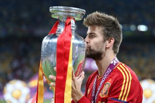 Gerard Pique kisses the Euro 2012 trophy after Spain