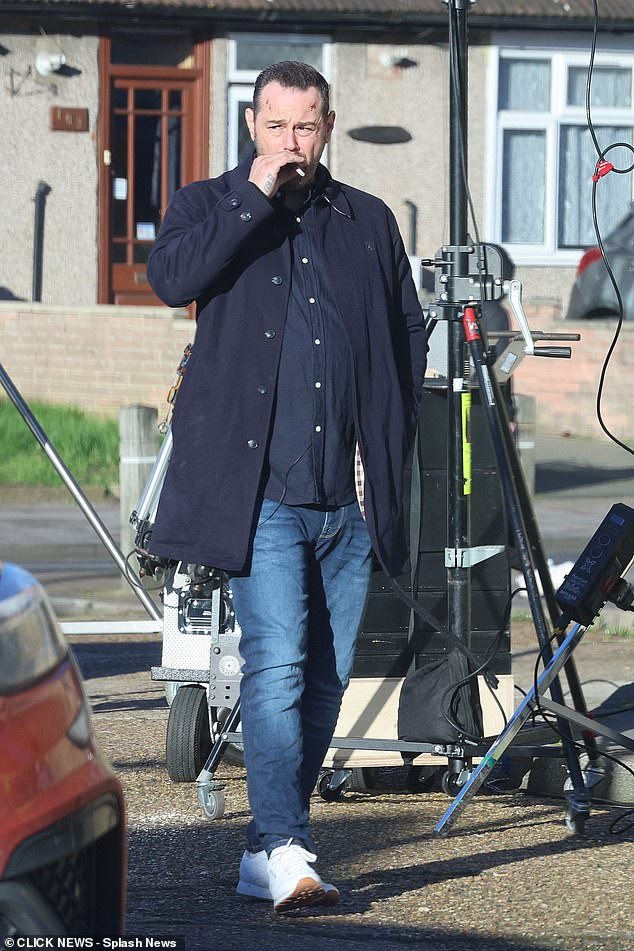 He was seen on set surrounded by the crew as he puffed on a cigarette, while sporting a bloody cut on his forehead
