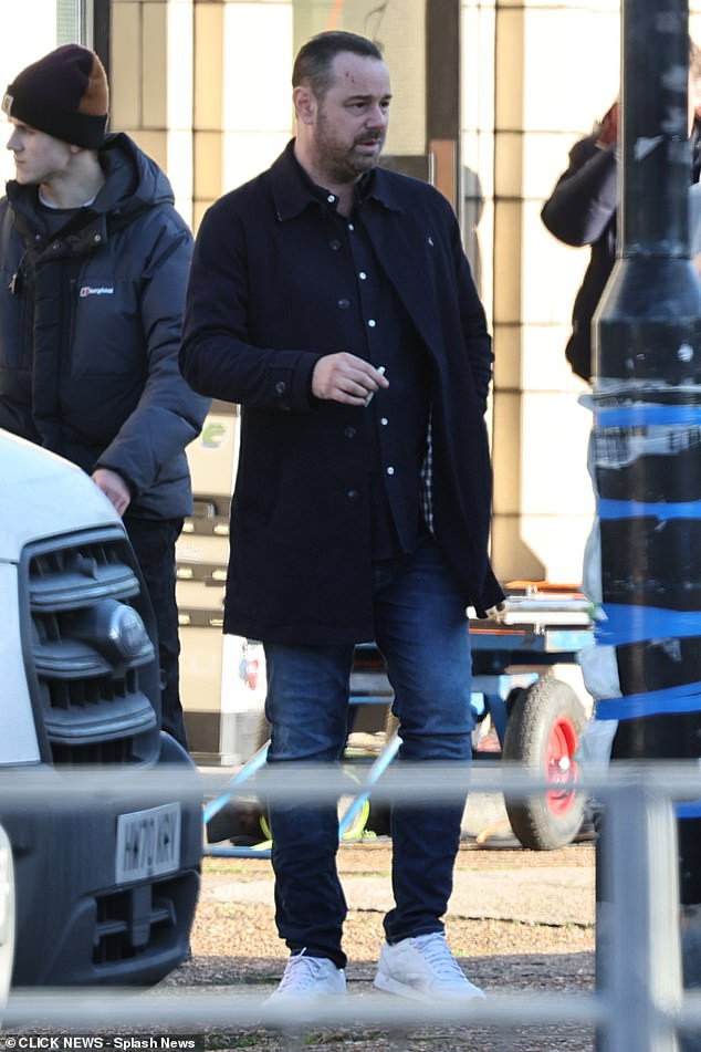 He cut a casual figure in a navy jacket over a coordinating button-up shirt, teamed with a pair of jeans and white trainers