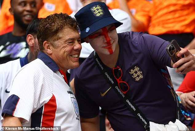 Andy Milne (L) has become known as an England superfan for regularly being seen at games