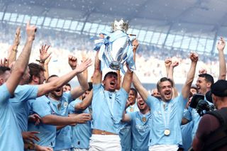 Manchester City players celebrate winning a fourth Premier League title