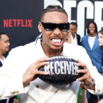 Justin Jefferson holding a football at the premiere of Receiver.