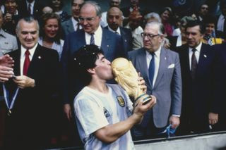 Diego Maradona kisses the World Cup trophy after Argentina