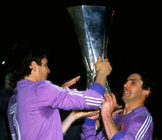 Real Madrid pair Jose Antonio Camacho and Santillana celebrate with the UEFA Cup trophy