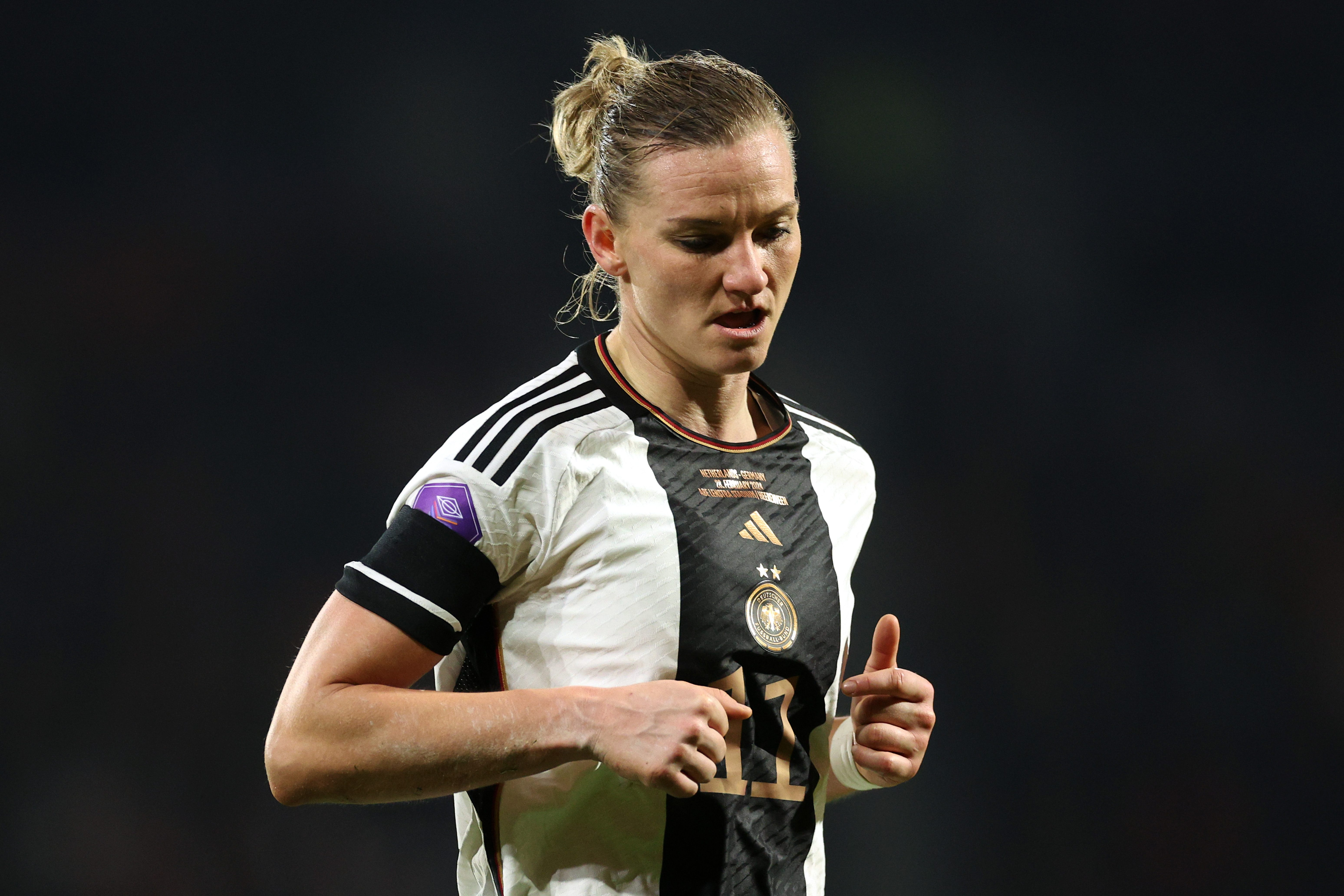 Alexandra Popp looks down as she runs for Germany