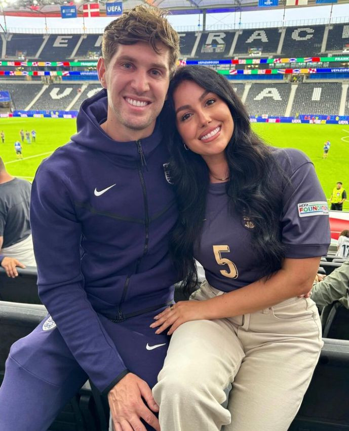 John Stones and Olivia Naylor inside a football stadium