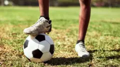 Close-up shot of a boy playing football