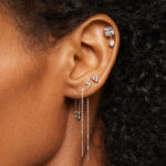 Football player with athletic tape covering ear piercings