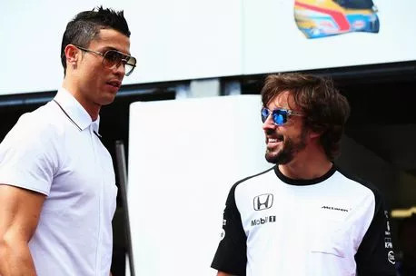 Real Madrid footballer Cristiano Ronaldo meets Fernando Alonso of Spain and McLaren Honda in the pitlane before the Monaco Formula One Grand Prix at Circuit de Monaco