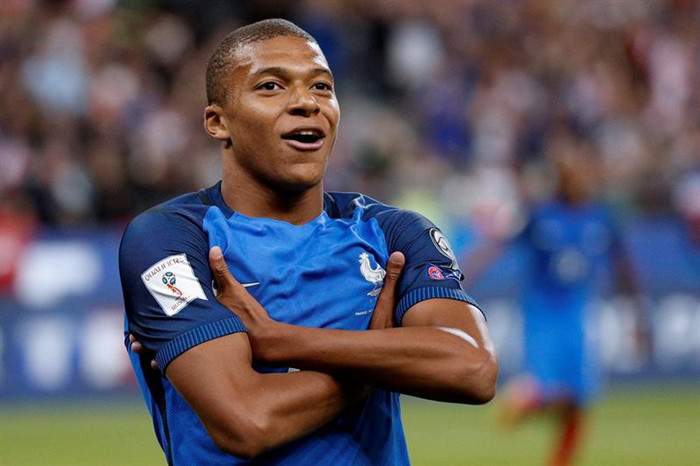 Kylian Mbappe's Two Hands Across the Chest