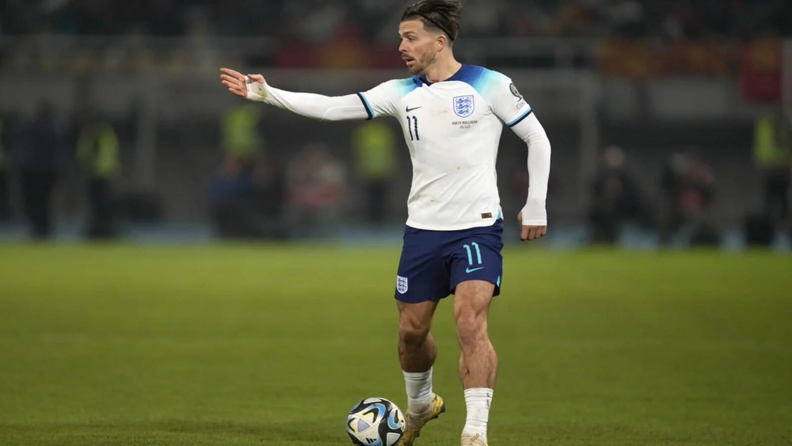 Jack Grealish dribbling for Manchester City, recognised among the highest paid Premier League players.