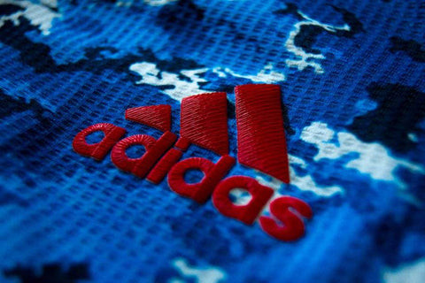 Adidas logo on a replica and player issue shirt