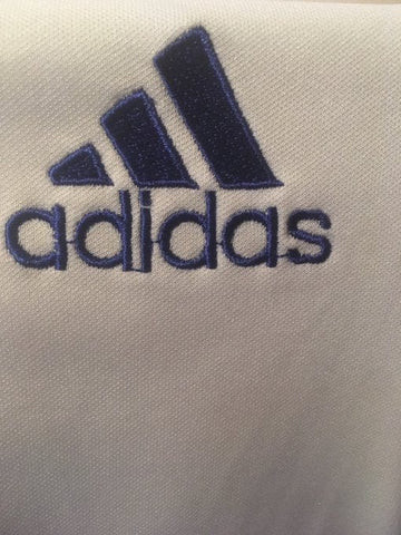 Examples of fake Adidas logos with issues like trailing stitches, thin typeface, and wonky stripes