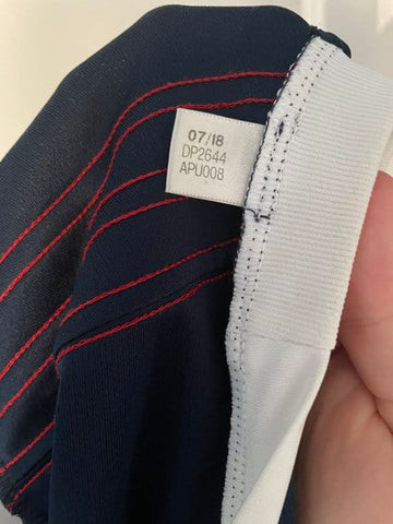 Example of a real product code tag inside the collar of an Adidas shirt