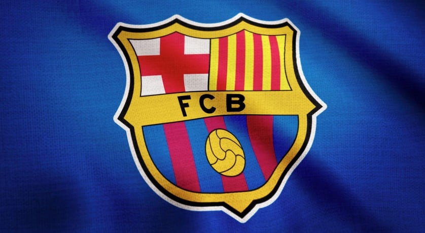 This image shows the iconic crest of FC Barcelona on a textured background that appears to be a section of the team