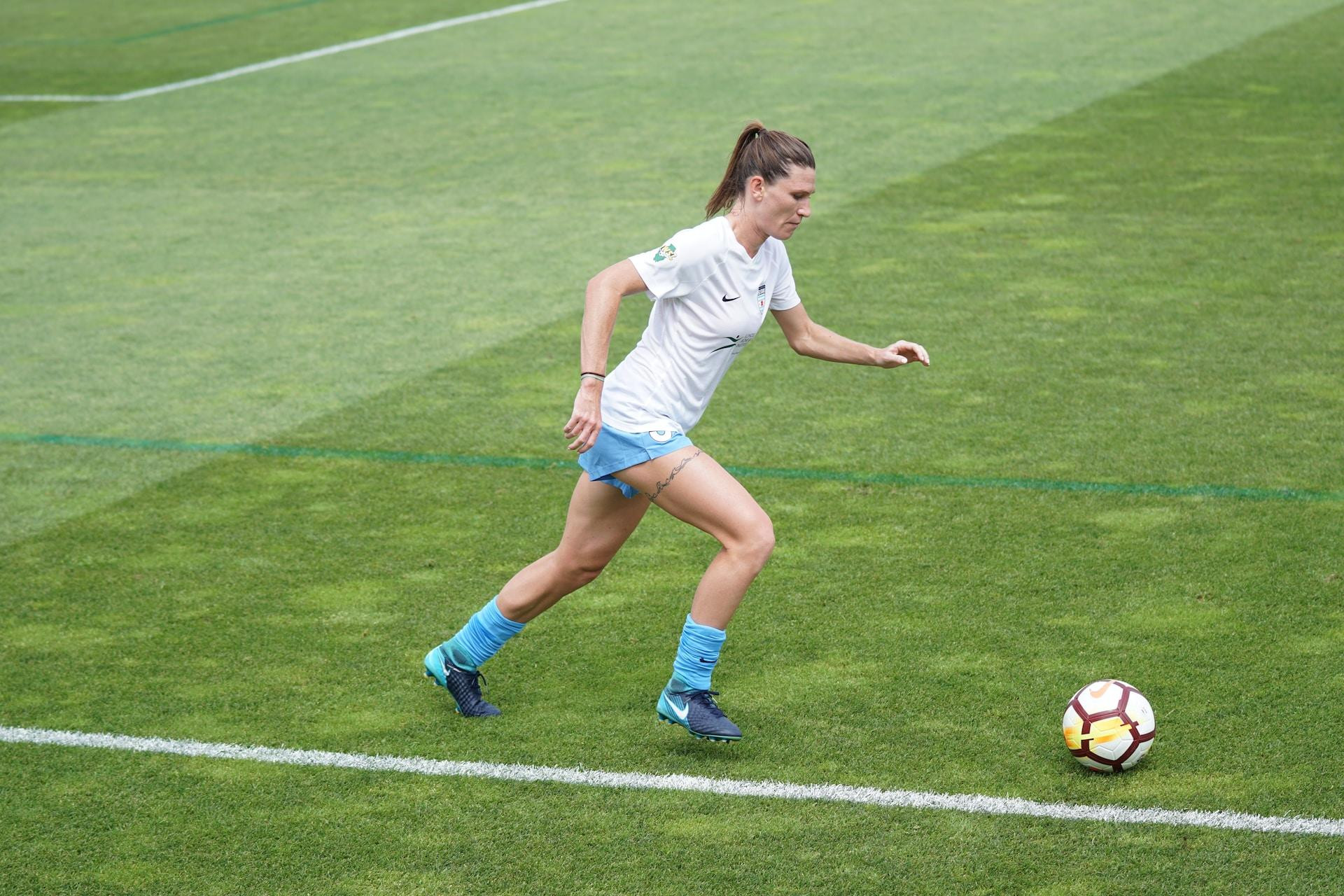 Female soccer player running with the ball