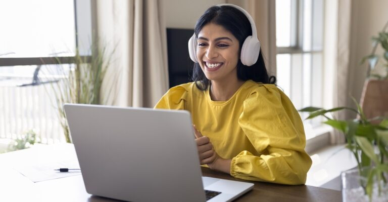 Young Indian woman learning the French adverbs in an online class at her laptop