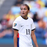 Soccer player scoring an own goal