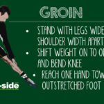 Athlete performing a groin static stretch during a football cool-down, sitting with feet together and gently pressing knees down to stretch inner thigh muscles