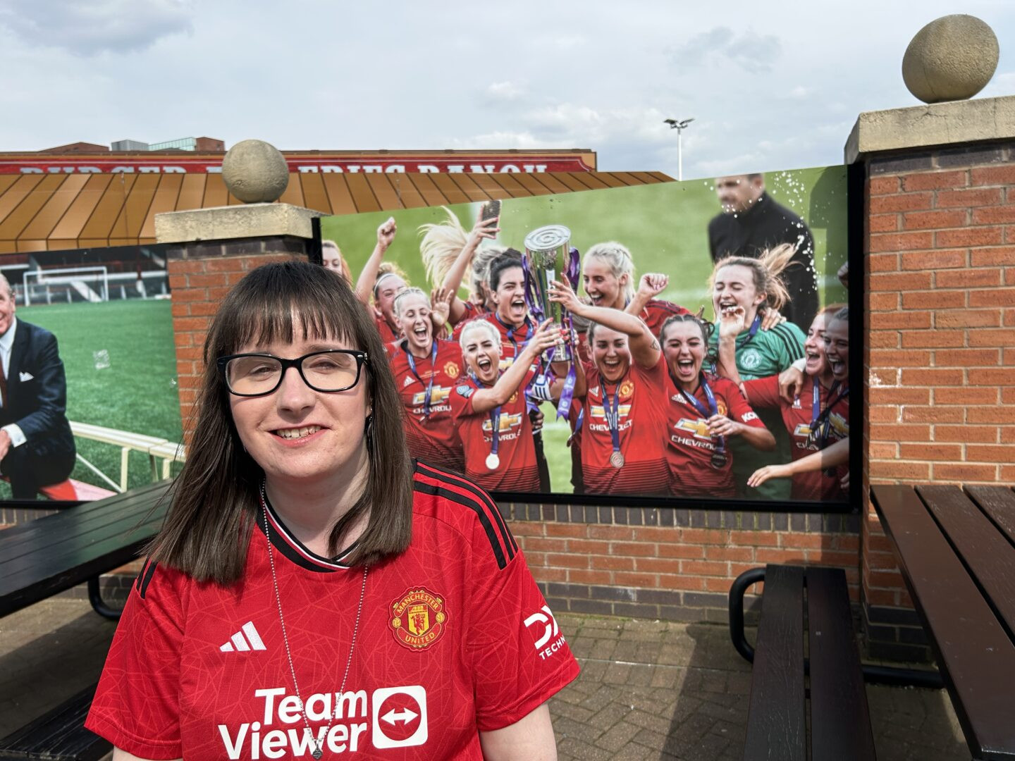 Holly stood in front of a Manchester United Women