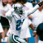 Deion Sanders dancing on his way to a pick 6
