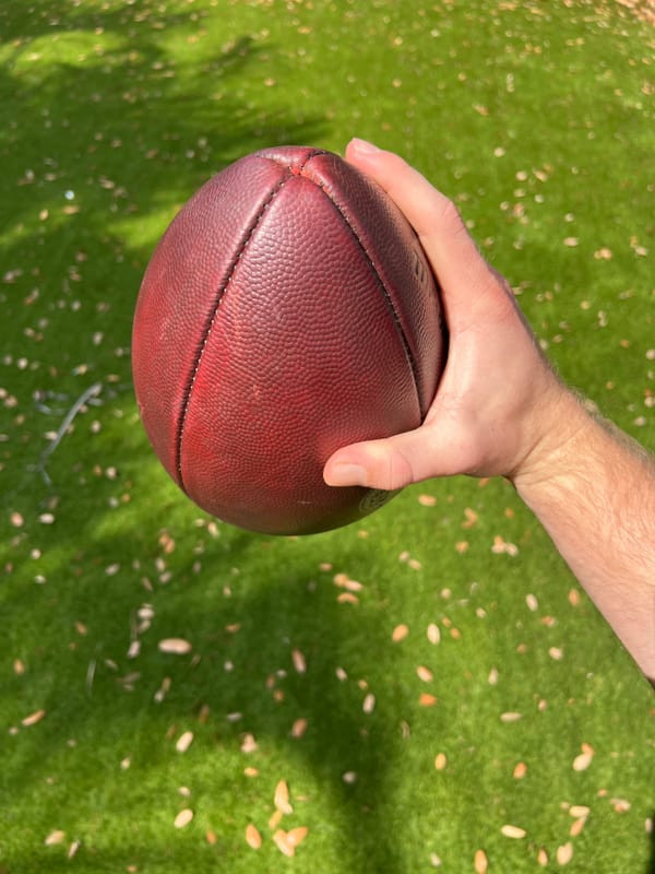 Neutral wrist position for enhanced football spin