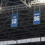 Retired numbers hanging in an NFL stadium
