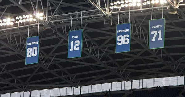 Retired numbers hanging in an NFL stadium