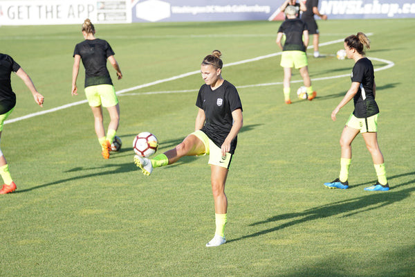 Football player practicing ball control skills during interval training